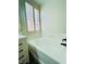 Bright bathroom with a white tiled tub, black fixtures, and natural light from the shuttered window at 8616 Willow Cabin St, Las Vegas, NV 89131