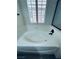 Large bathtub featuring wood look flooring and a window with white shutter, perfect for relaxation at 8616 Willow Cabin St, Las Vegas, NV 89131