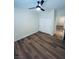Bright bedroom featuring wood-look flooring and a ceiling fan, complemented by a double-door closet for storage at 8616 Willow Cabin St, Las Vegas, NV 89131