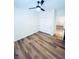 A simple bedroom features wood-look flooring, a ceiling fan, and a sliding-door closet at 8616 Willow Cabin St, Las Vegas, NV 89131