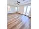 Bedroom featuring wood-look floors, bright windows and ceiling fan at 8616 Willow Cabin St, Las Vegas, NV 89131