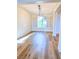 Dining room with wood-look floors, shuttered windows and contemporary chandelier at 8616 Willow Cabin St, Las Vegas, NV 89131