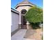 Charming entryway featuring a wrought iron security gate and mature landscaping at 8616 Willow Cabin St, Las Vegas, NV 89131