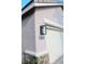 A charming home exterior boasts a well-maintained garage, stylish lighting and clear numbering at 8616 Willow Cabin St, Las Vegas, NV 89131
