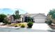 Well-maintained single-story home featuring desert landscaping, mature trees, and an attached two-car garage at 8616 Willow Cabin St, Las Vegas, NV 89131