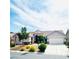 Single-story home featuring desert landscaping, and a three-car garage at 8616 Willow Cabin St, Las Vegas, NV 89131