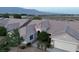 Aerial view of a single-story home with a well-manicured yard and a mountain backdrop at 8616 Willow Cabin St, Las Vegas, NV 89131
