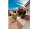 Charming front yard with walkway, gravel landscaping, mature trees and lush greenery at 8616 Willow Cabin St, Las Vegas, NV 89131
