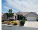 Charming single-story home featuring a well-manicured front yard and a two-car garage at 8616 Willow Cabin St, Las Vegas, NV 89131