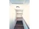 Hallway with custom shelving, wood-look floors, a skylight, and natural lighting at 8616 Willow Cabin St, Las Vegas, NV 89131