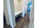 Hallway featuring wood-look flooring, built-in desk area, and a view leading into another room at 8616 Willow Cabin St, Las Vegas, NV 89131