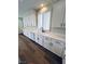 Beautiful white kitchen with modern fixtures, shaker cabinets, and hardwood floors at 8616 Willow Cabin St, Las Vegas, NV 89131