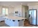 Modern kitchen features an island, stainless steel appliances, and white cabinets and countertops at 8616 Willow Cabin St, Las Vegas, NV 89131