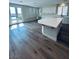 Eat-in kitchen with an island, white cabinets, stainless steel appliances, and new floors at 8616 Willow Cabin St, Las Vegas, NV 89131