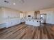 Modern kitchen features a large island with a breakfast bar, stainless steel appliances, and custom lighting at 8616 Willow Cabin St, Las Vegas, NV 89131