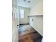 Laundry room with wood-look flooring, floating shelves, a window, and washer and dryer hookups at 8616 Willow Cabin St, Las Vegas, NV 89131