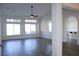 Spacious living room boasting large windows, plantation shutters, a ceiling fan, and wood-look flooring at 8616 Willow Cabin St, Las Vegas, NV 89131