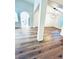 A bright living area with wood-look floors, an archway, and a modern light fixture at 8616 Willow Cabin St, Las Vegas, NV 89131