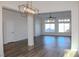 Open living room featuring wood-look floors and bright windows at 8616 Willow Cabin St, Las Vegas, NV 89131