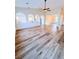 Open living space with high ceilings, wood-look floors, and arched details to the kitchen at 8616 Willow Cabin St, Las Vegas, NV 89131