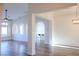 Open-concept living room featuring archways, recessed lighting, and seamless wood-look flooring at 8616 Willow Cabin St, Las Vegas, NV 89131