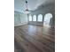 Bright living room featuring new floors, white trim, modern lighting, and arched windows at 8616 Willow Cabin St, Las Vegas, NV 89131