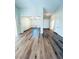 An open-concept living space showcases wood-look floors and an archway entrance to an adjoining room at 8616 Willow Cabin St, Las Vegas, NV 89131