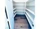 Spacious walk-in pantry with custom shelving and wood-look flooring offers ample storage space at 8616 Willow Cabin St, Las Vegas, NV 89131
