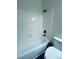 The shower is a standard tub-shower combination with white acrylic walls and black fixtures at 8616 Willow Cabin St, Las Vegas, NV 89131