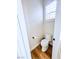 A tidy powder room featuring a toilet and crisp white trim with a bright window at 8616 Willow Cabin St, Las Vegas, NV 89131