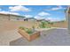 Landscaped backyard with gravel, brick paved patio, brick wall, and raised garden at 8852 Flora Run Ave, Las Vegas, NV 89166