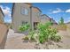 Residential backyard with a brick paved patio, gravel, and trees at 8852 Flora Run Ave, Las Vegas, NV 89166