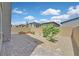 Brick paved patio with gravel and trees in this suburban backyard at 8852 Flora Run Ave, Las Vegas, NV 89166