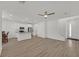 Bright, open-concept living space features modern hardwood floors, recessed lighting, and an attached kitchen with stainless appliances at 8852 Flora Run Ave, Las Vegas, NV 89166