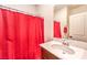 Modern bathroom with a clean vanity and decorative shower curtain at 9114 Riverlands Ranch St, Las Vegas, NV 89139