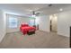 Bedroom with neutral carpet, ceiling fan, and a red bed set, with an ensuite bathroom at 9114 Riverlands Ranch St, Las Vegas, NV 89139