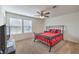 Bedroom with two windows and a metal frame bed plus a ceiling fan at 9114 Riverlands Ranch St, Las Vegas, NV 89139