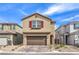 Charming two-story home featuring a brick driveway, two-car garage, red shutters, and low-maintenance landscaping at 9114 Riverlands Ranch St, Las Vegas, NV 89139