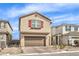 Charming two-story home featuring a brick driveway, two-car garage, red shutters, and low-maintenance landscaping at 9114 Riverlands Ranch St, Las Vegas, NV 89139