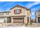 Charming two-story home featuring a brick driveway, two-car garage, red shutters, and low-maintenance landscaping at 9114 Riverlands Ranch St, Las Vegas, NV 89139
