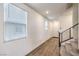 Inviting foyer featuring a wood floor, staircase, and modern railings, with an abundance of natural light at 9114 Riverlands Ranch St, Las Vegas, NV 89139