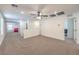 Spacious loft area with neutral carpet, ceiling fan, and access to other rooms at 9114 Riverlands Ranch St, Las Vegas, NV 89139