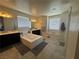 Bright bathroom featuring double sinks, a soaking tub, and ceramic tile flooring at 933 Kimbark Ave, Las Vegas, NV 89148