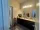 Dual sink bathroom with plenty of counter space and good lighting fixtures at 933 Kimbark Ave, Las Vegas, NV 89148