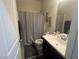 Bathroom features vanity with marble countertop, mirror and shower/tub with curtain at 933 Kimbark Ave, Las Vegas, NV 89148