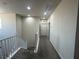 Upstairs hallway with stairs and neutral carpet, paint, and fixtures at 933 Kimbark Ave, Las Vegas, NV 89148