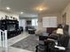 Cozy living room featuring plush gray carpet and ample seating at 933 Kimbark Ave, Las Vegas, NV 89148