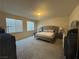 Spacious main bedroom featuring a plush bed, carpet flooring, and natural light at 933 Kimbark Ave, Las Vegas, NV 89148