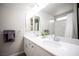 Bathroom featuring a double sink vanity with chrome fixtures, and a large mirror at 9807 Panther Hollow St, Las Vegas, NV 89141