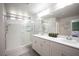 Modern bathroom with dual sinks, a large walk-in shower with glass doors, and neutral decor at 9807 Panther Hollow St, Las Vegas, NV 89141